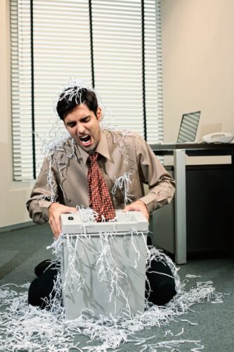 A man sitting on the ground covered in ice.